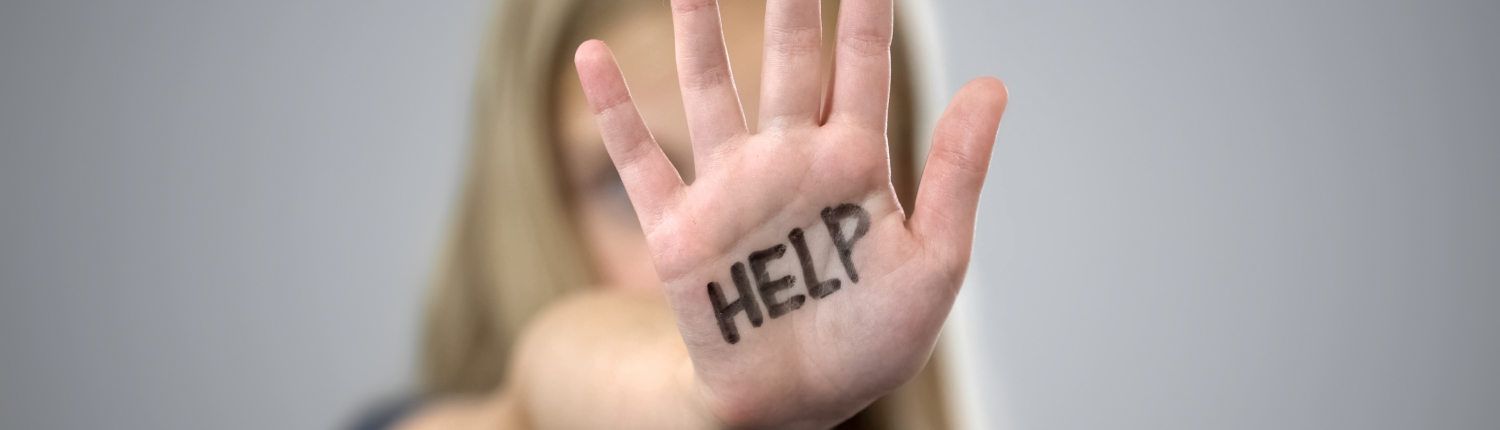 Help inscription on palm of sad little girl, protection of childrens rights